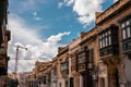 Road in the city of Valletta packed with cars and other traffic. Typical street in the mediterranean island of Malta on a rainy