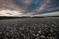 Road close-up with mountains in the distance and a dramatic sunset sky Royalty Free Stock Photo