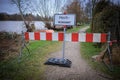 A road is closed with a barrier and a sign with the German inscription: Flood Royalty Free Stock Photo