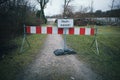 A road is closed with a barrier and a sign with the German inscription: Flood Royalty Free Stock Photo