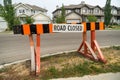 Road closed barrier on residential street curb Royalty Free Stock Photo