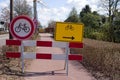 Road closed with roadblocks and a detour sign