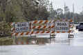 Road closed for roadworks and danger of flooding with warning signs blocking driving of cars Royalty Free Stock Photo