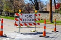 Road closed sign in the middle of four lane highway in residential neighborhood in early spring Royalty Free Stock Photo