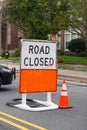 Road closed sign on top of a blank orange road sign Royalty Free Stock Photo