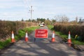 Road Closed sign with traffic cones on country road. UK