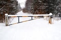 The road is closed on a snowy road in winter. The barrier is closed, the obstacle is on the way Royalty Free Stock Photo