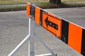 A road closer with arrow construction barrier