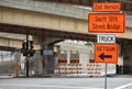 Traffic detour signs in downtown rush hour with traffic light road closure