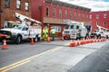 Road closure. Verizon workmen lowering cable into a manhole. Verizon special equipment for Internet debugging