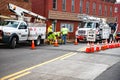 Road closure. Verizon workmen lowering cable into a manhole. Verizon special equipment for Internet debugging