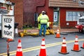 Road closure. Verizon workmen lowering cable into a manhole. Verizon special equipment for Internet debugging