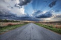 Road with cloudy sunset with rain Royalty Free Stock Photo