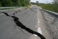 Road collapses with huge cracks. Flood damage highway. Asphalt road collapsed and fallen after heavy flood or earthquake Royalty Free Stock Photo