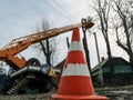 Road cone used during spring pruning of trees with bucket truck and aerial device. Pollarding trees among electricity lines,