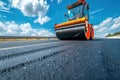 Road construction asphalt paving with a steamroller machine on the new road surface Royalty Free Stock Photo