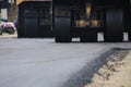 Road construction asphalt road by worker and roller machine. Asphalt road background Royalty Free Stock Photo