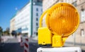 Road construction concept. Orange warning light. Blur city background, space Royalty Free Stock Photo