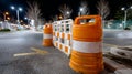 Road construction cones and barrier at night on empty street. Royalty Free Stock Photo