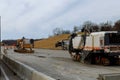 Road construction equipment are working on a new road construction repair route