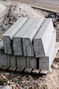 Road construction materials stacked on a pallet. Concrete curb f Royalty Free Stock Photo