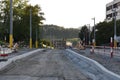 Road construction with new street lights on both sides in final phase