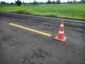 Road construction with a red rubber cone in front Royalty Free Stock Photo
