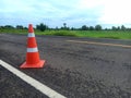 Road construction with a red rubber cone in front Royalty Free Stock Photo