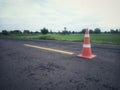 Road construction with a red rubber cone in front Royalty Free Stock Photo