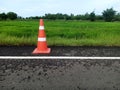 Road construction with a red rubber cone in front Royalty Free Stock Photo