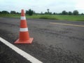 Road construction with a red rubber cone in front Royalty Free Stock Photo