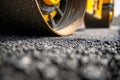 Road construction roller compacting freshly laid asphalt to create a smooth and durable surface during highway maintenance work on Royalty Free Stock Photo