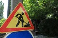 Road construction sign on city street, space for text. Repair works Royalty Free Stock Photo