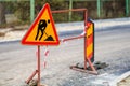 Road construction sign on urban street indicating ongoing work zone Royalty Free Stock Photo