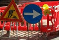 road construction site in the city and the signs with the arrow and the yellow flashing light Royalty Free Stock Photo