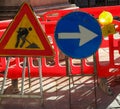 road construction site in the city and the signs with the arrow and the yellow flashing light Royalty Free Stock Photo