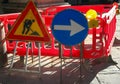 road construction site in the city and the signs with the arrow and the yellow flashing light Royalty Free Stock Photo