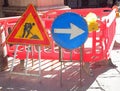 road construction site in city and signs with the big arrow and the yellow flashing light Royalty Free Stock Photo