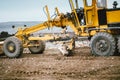 Highway construction site development with motor grader moving earth, soil Royalty Free Stock Photo