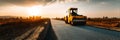 Road Construction at Sunset With a Steamroller Working on a Smooth Surface in a Rural Landscape Royalty Free Stock Photo