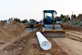 Road construction using road machinery. Soil compactor and dozer at construction site. Heavy machinery for road work. Building a