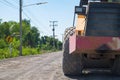 Road construction vehicle on the rough rural road. Royalty Free Stock Photo