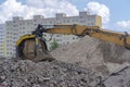 Road building. Heaps of stones and substrate. Visible excavator arm with rotating screen. Royalty Free Stock Photo