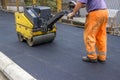 Road construction worker behind construction roller Royalty Free Stock Photo