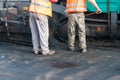 Road construction workers, asphalting machinery. Royalty Free Stock Photo