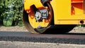 Close-up, Road construction works with roller compactor machine and asphalt finisher. Road roller laying fresh asphalt