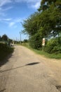 Road in the countryside that leads to a railroad crossing Royalty Free Stock Photo