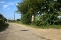 Road in the countryside that leads to a railroad crossing Royalty Free Stock Photo