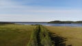 Road in the countryside. path among the green woods and water in the reservoir top view. areal view road through the green forest. Royalty Free Stock Photo