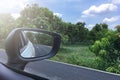 Road countryside Reflection of sunny autumn road at the car side mirror. Royalty Free Stock Photo